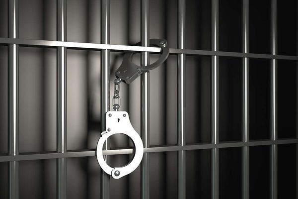 Metal prison bars with handcuffs