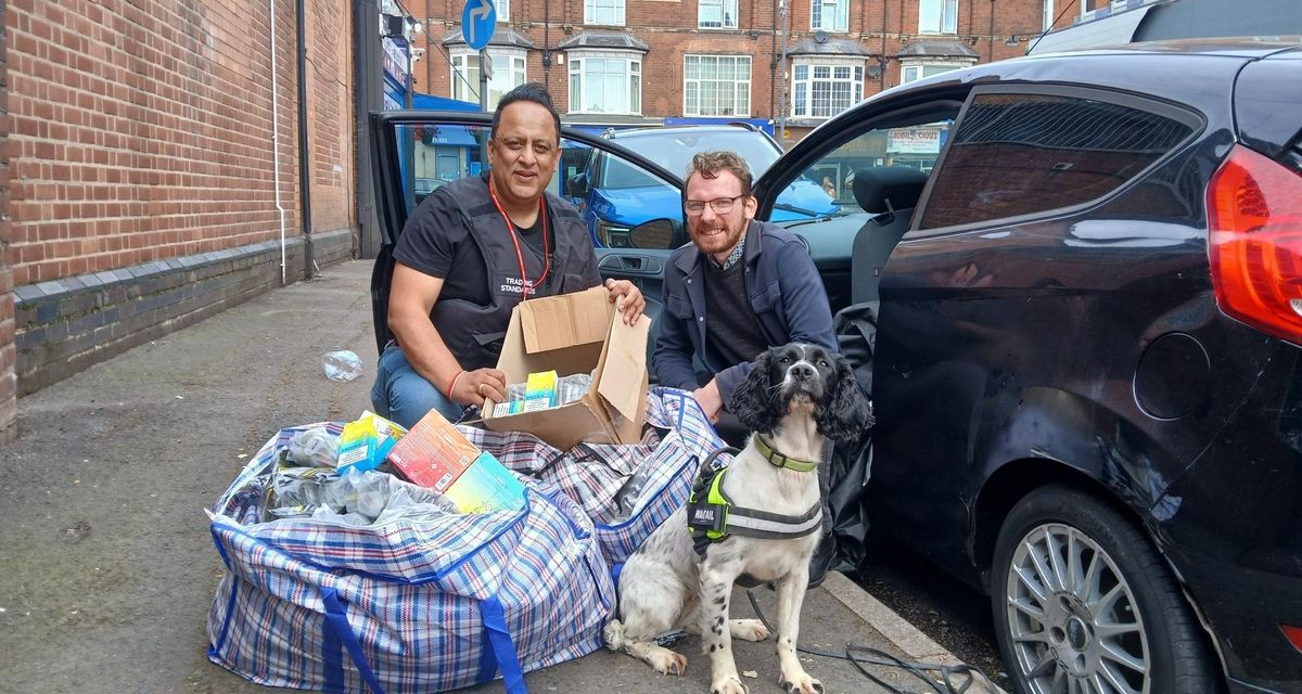 ​Mohammed Tariq, Senior Trading Standards Officer at Birmingham City Council, and Councillor Jamie Tennant with large bag of seized goods