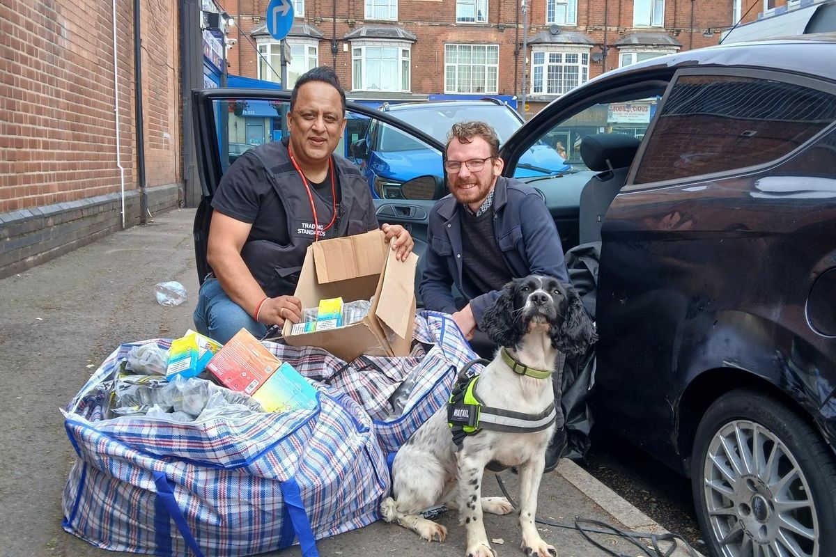 Mohammed Tariq, Senior Trading Standards Officer at Birmingham City Council, and Councillor Jamie Tennant with large bag of seized goods