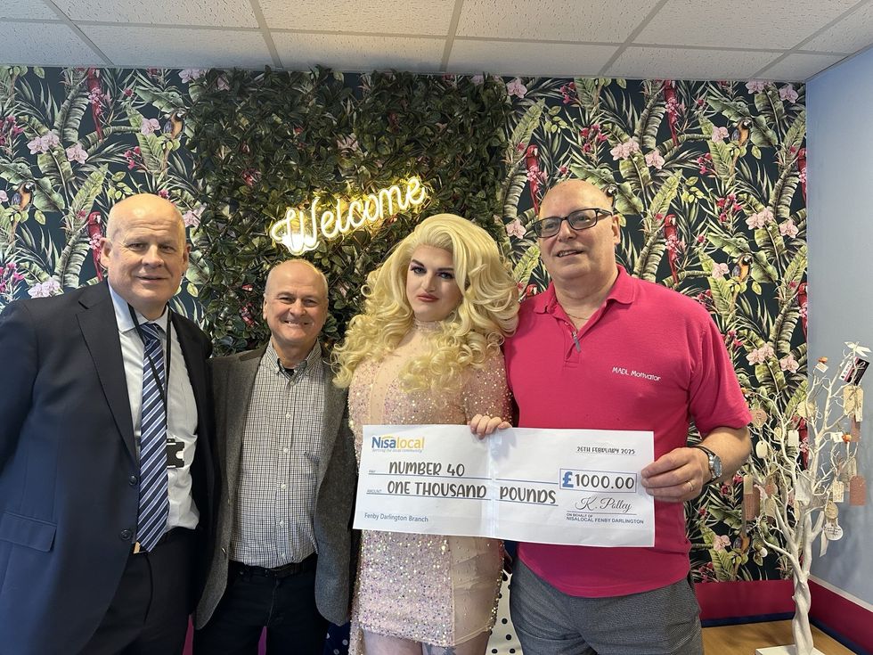 Nisa Local store owners presenting Pride Pot donation to LGBTQ+ initiative organizers