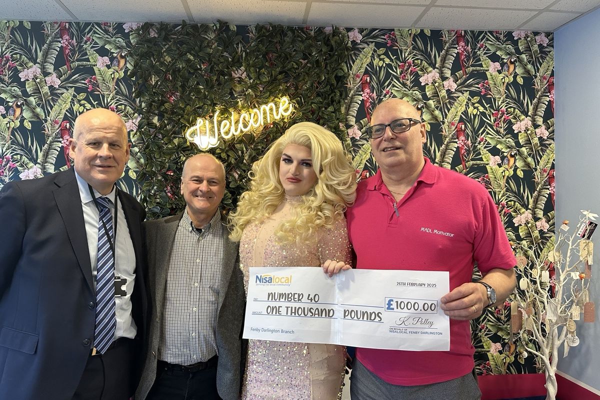 Nisa Local store owners presenting Pride Pot donation to LGBTQ+ initiative organizers