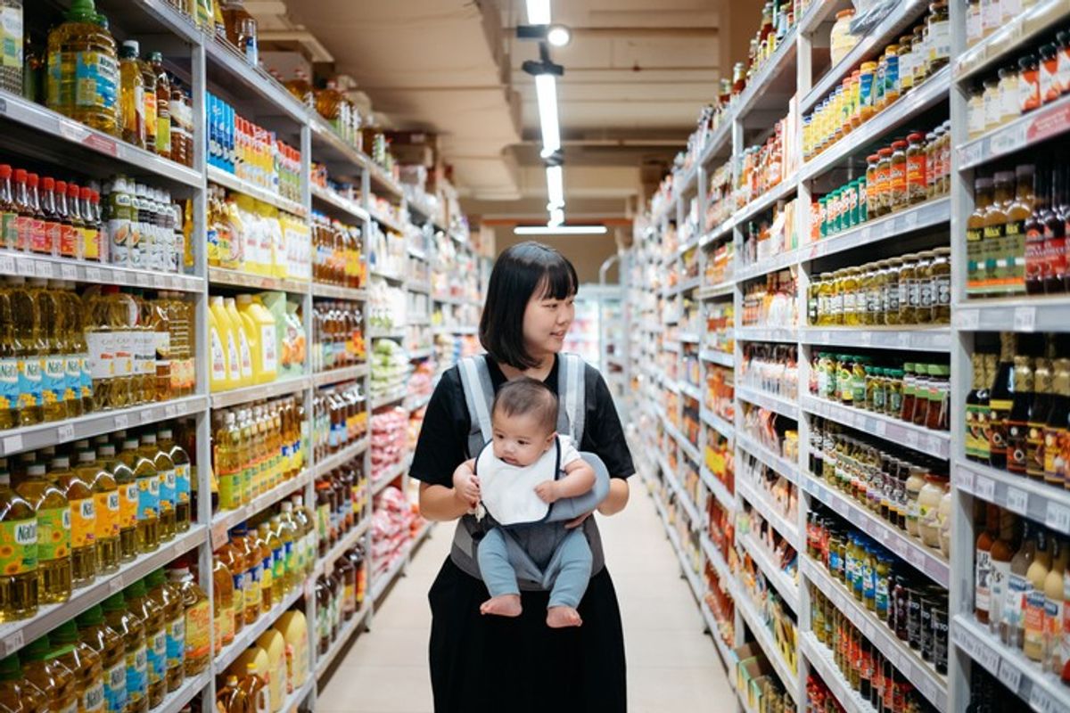 Parents shopping for baby essentials at a local convenience store