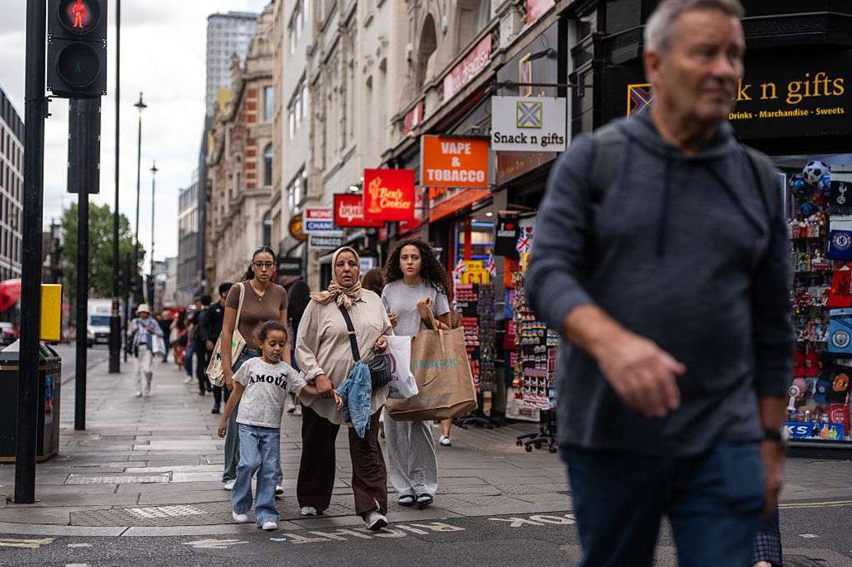 People pass along Oxford Street in London