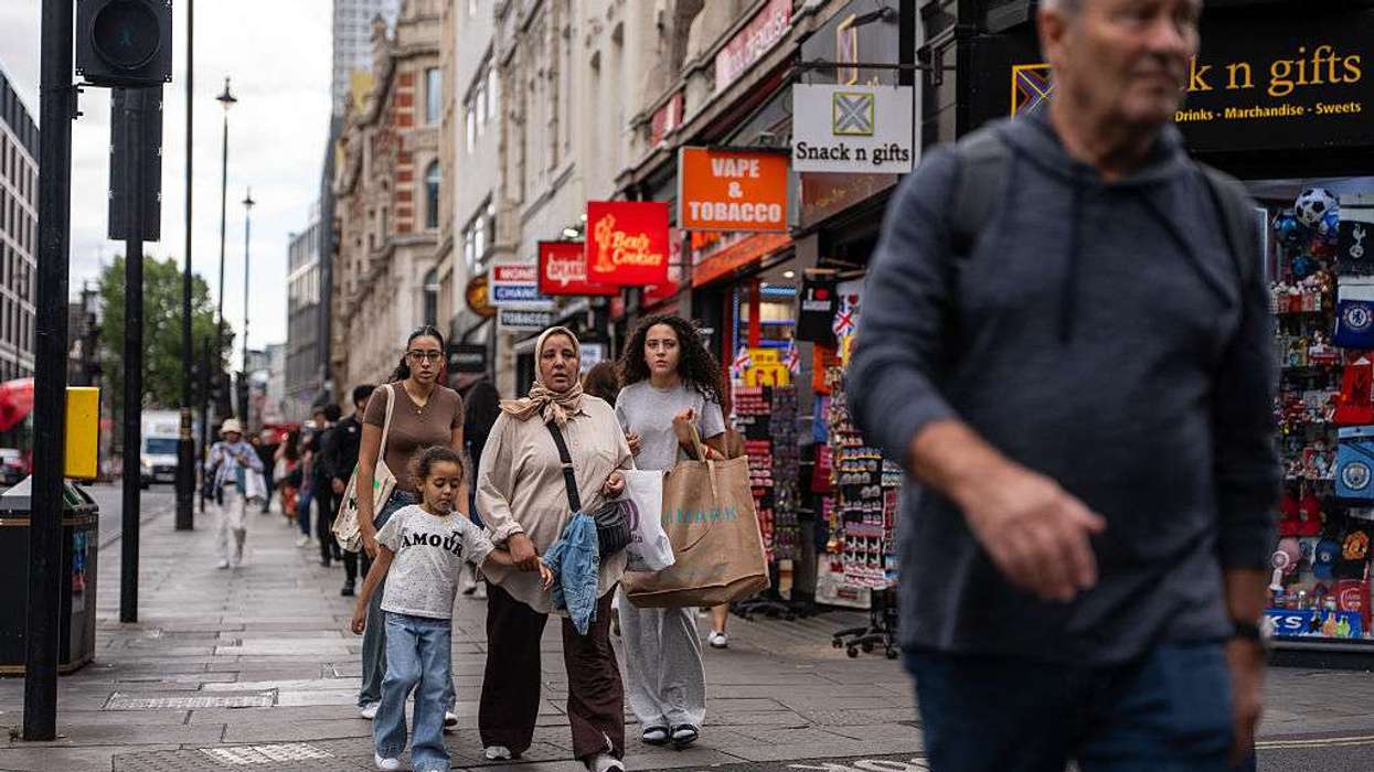 People pass along Oxford Street in London