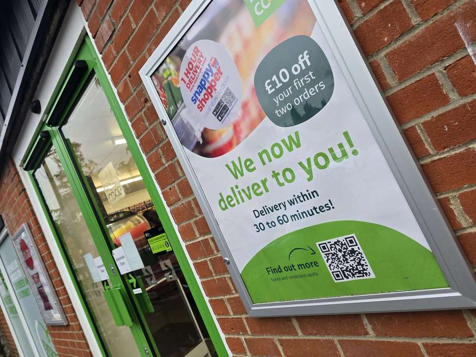 Poster of Snappy Shopper service in front of an East of England Co-op store