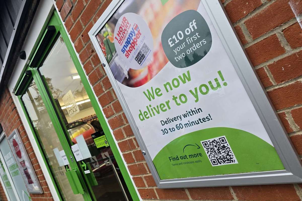 Poster of Snappy Shopper service in front of an East of England Co-op store