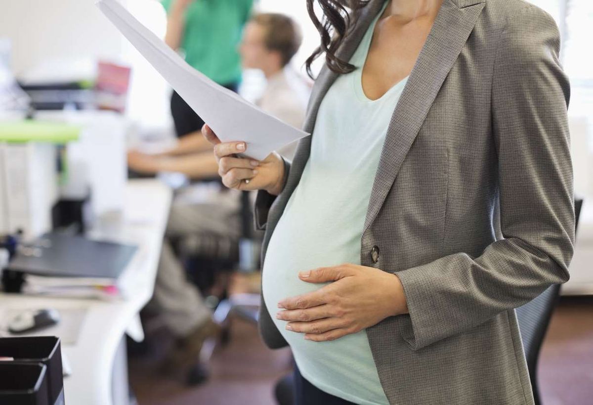 Pregnant businesswoman working in office