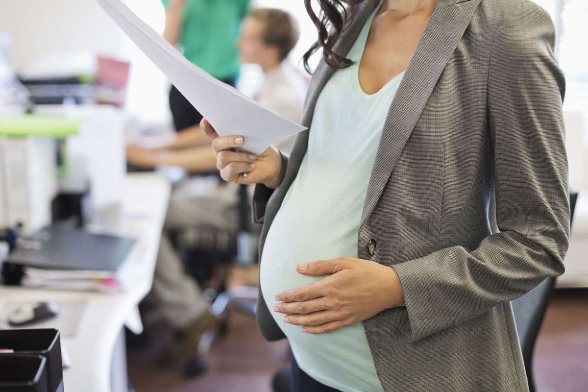 Pregnant businesswoman working in office