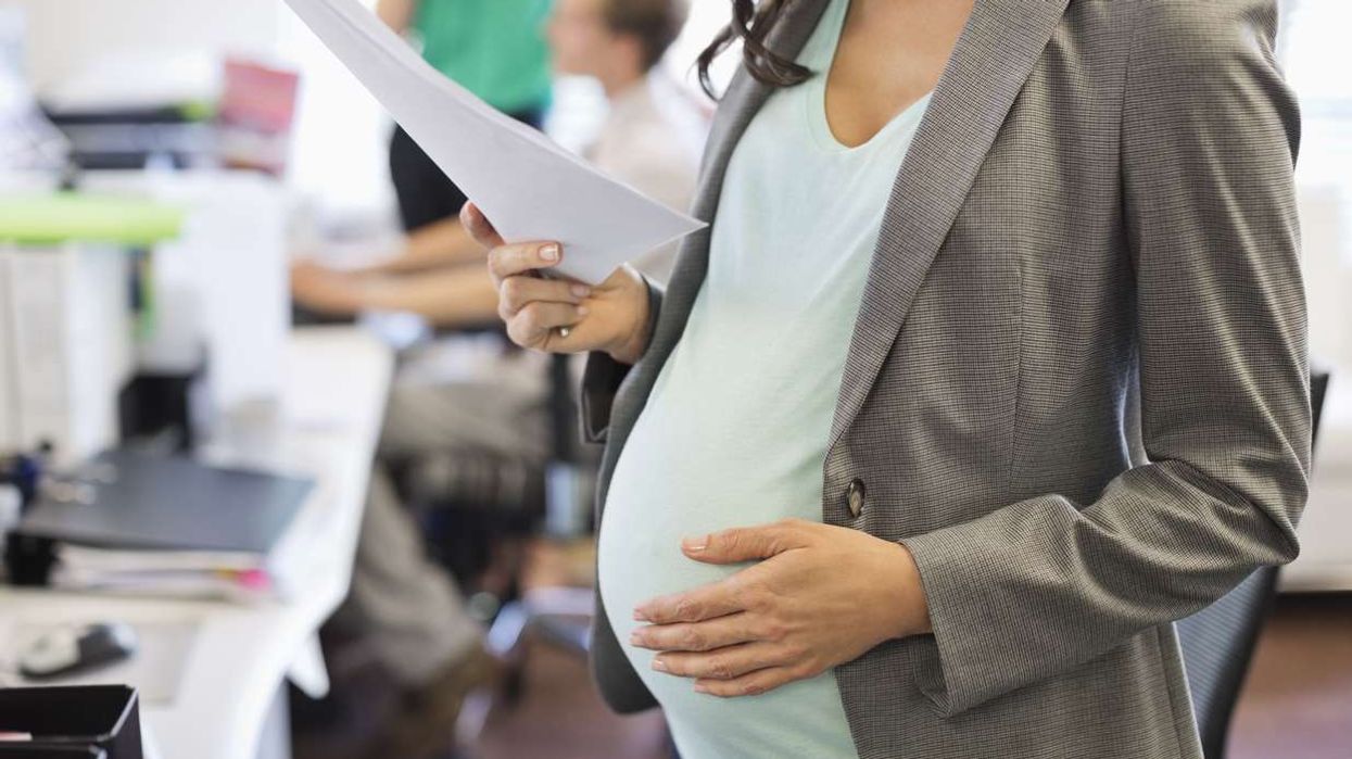 Pregnant businesswoman working in office