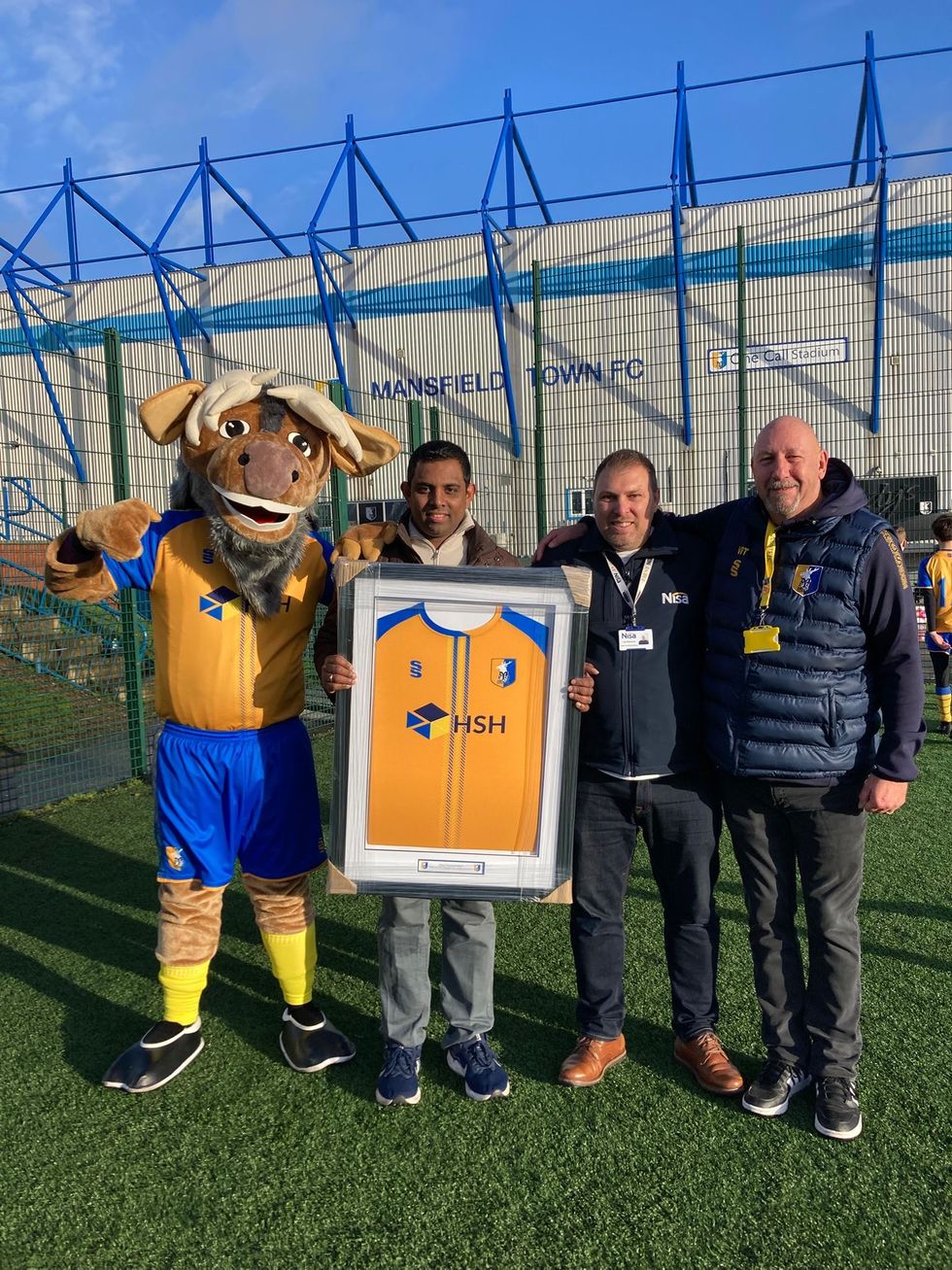 Prem Uthayakumaran is awarded a shirt outside Mansfield's One Call Stadium