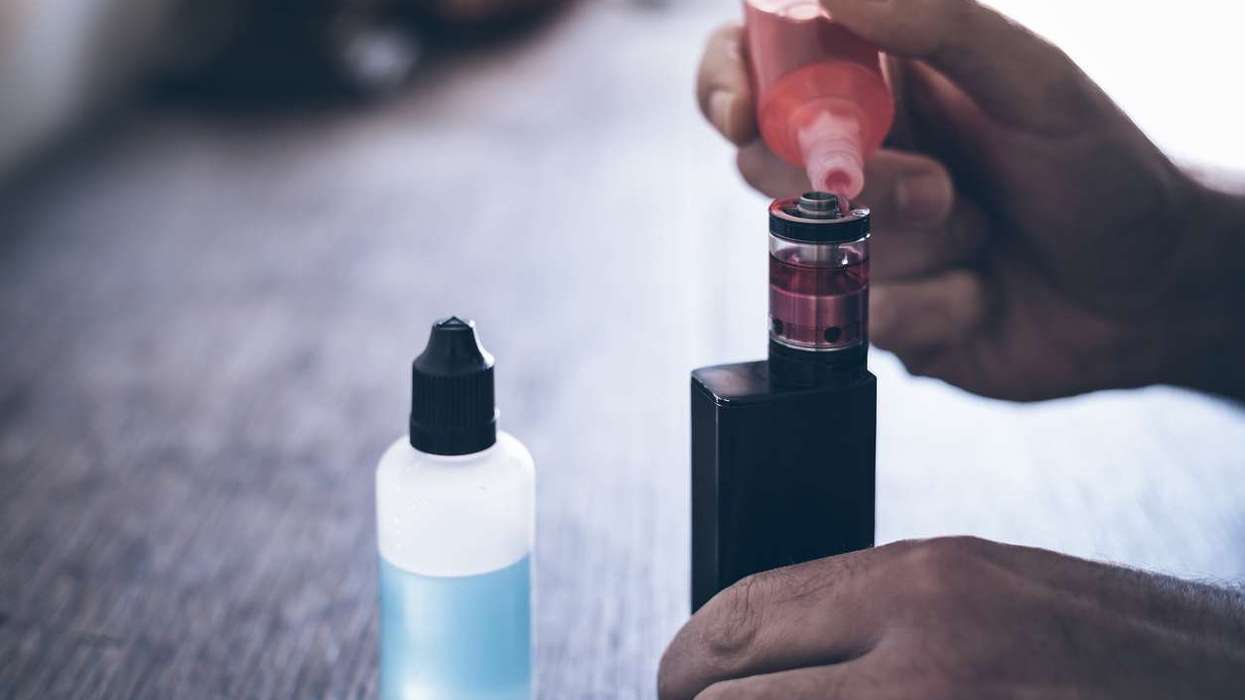 refilling the tank of an e-cigarette with vape liquid