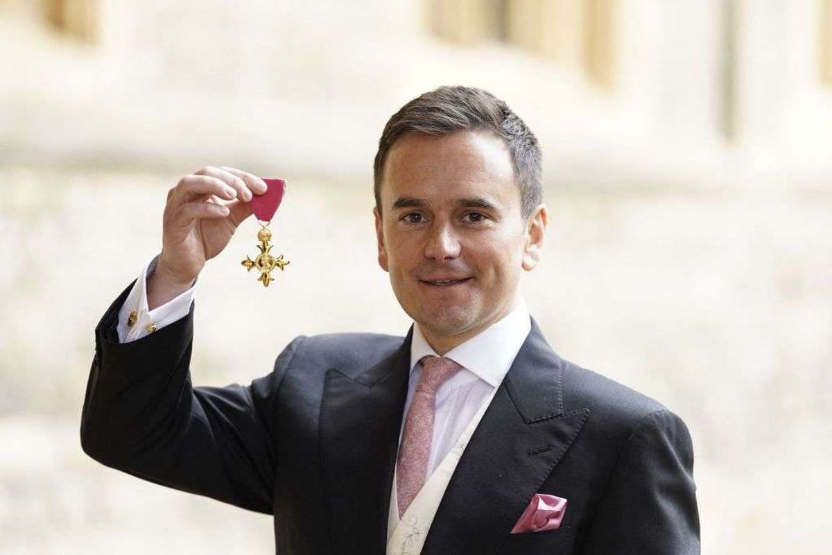 Richard Walker poses with his OBE medal