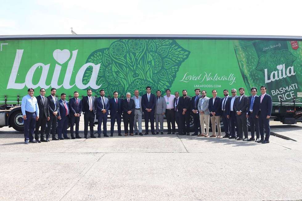 Senior leaders from REAP delegation with Kewal & Harry Dulai in front of Laila branded truck