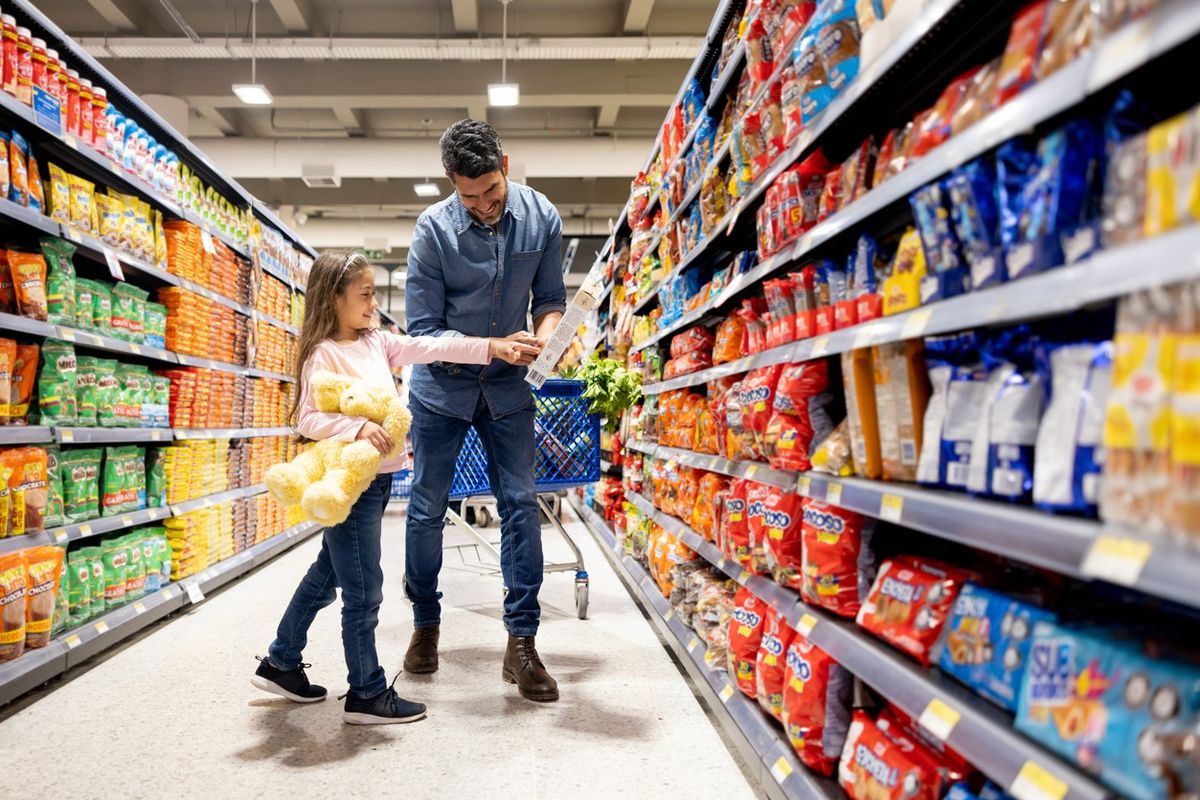 Shoppers browsing food and household items in a UK store-