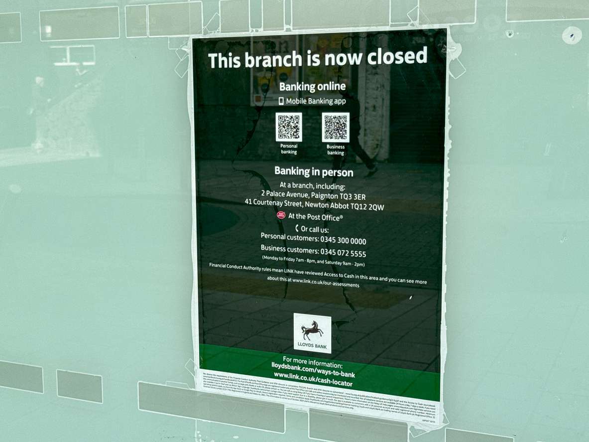 Sign on the window of the branch of Lloyds Bank which has closed down