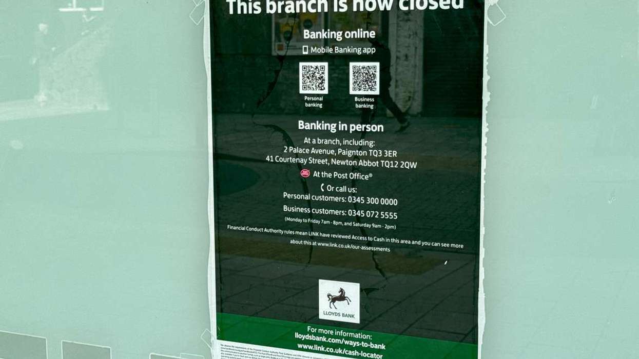 Sign on the window of the branch of Lloyds Bank which has closed down
