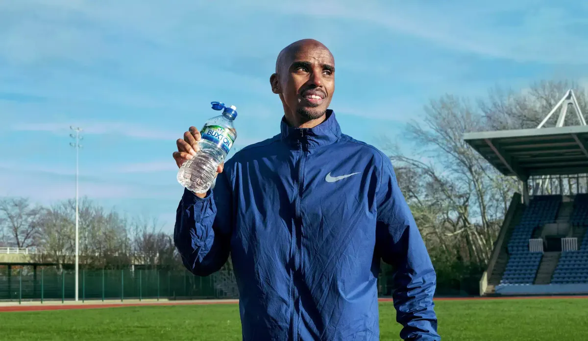 ​Sir Mo Farah holding a bottle of Buxton