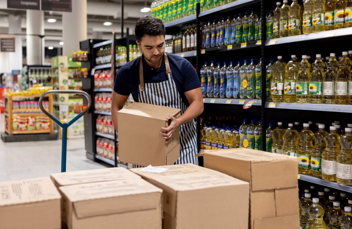 Staff working at the supermarket restocking the shelves