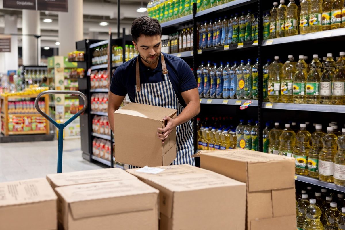 Staff working at the supermarket restocking the shelves