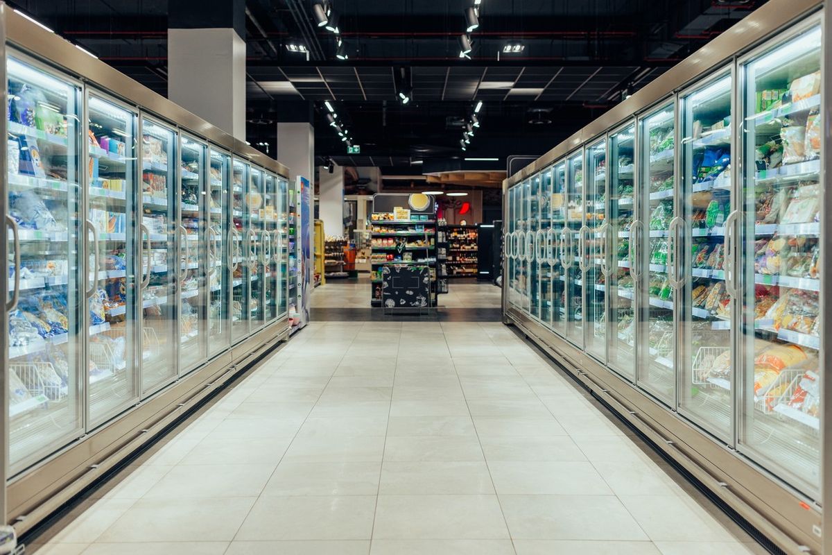 supermarket aisle with refrigerators