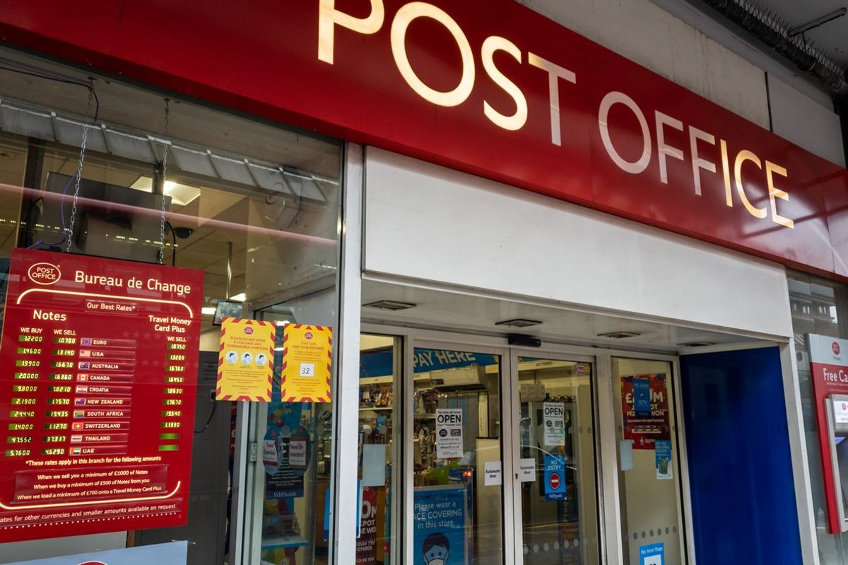 The shop sign and entrance of a branch of the Post Office.