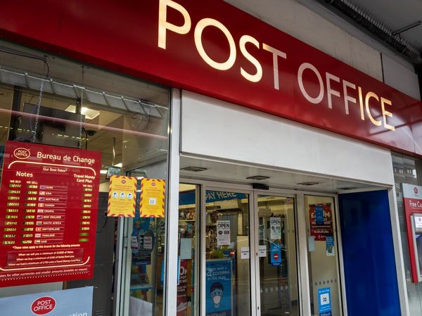 The shop sign and entrance of a branch of the Post Office