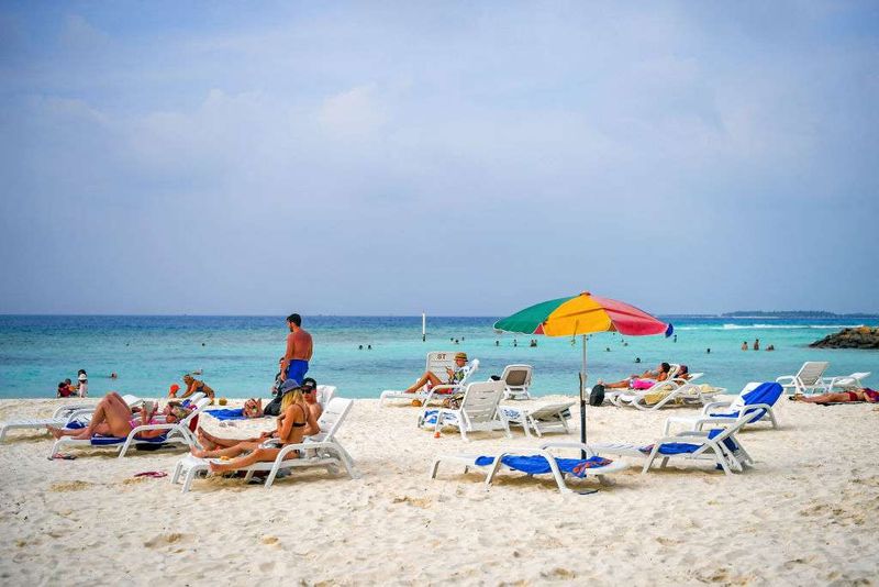 Tourists relax at a beach in Maafushi, an island in Maldives