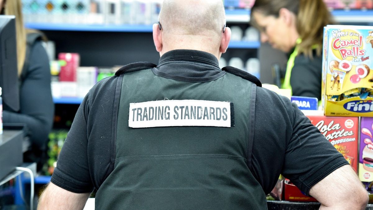Trading Standards officers seizing illegal vapes and cigarettes from a convenience store