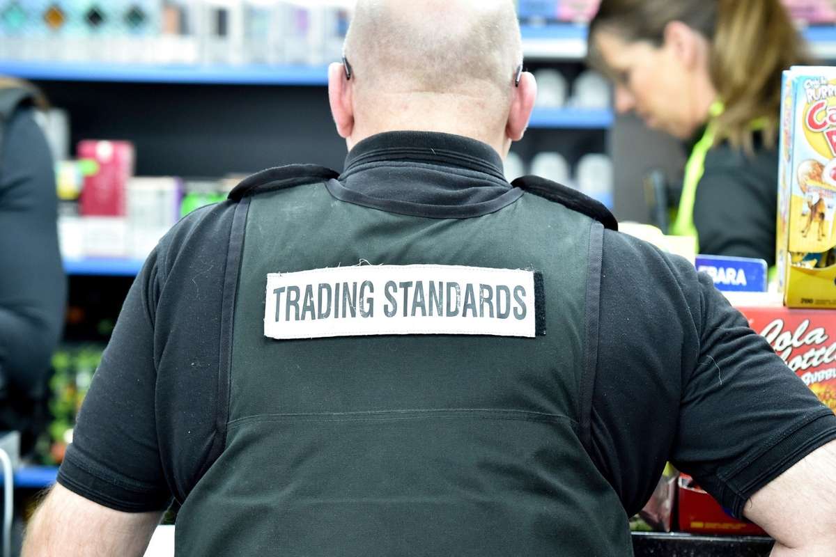 Trading Standards officers seizing illegal vapes and cigarettes from a convenience store
