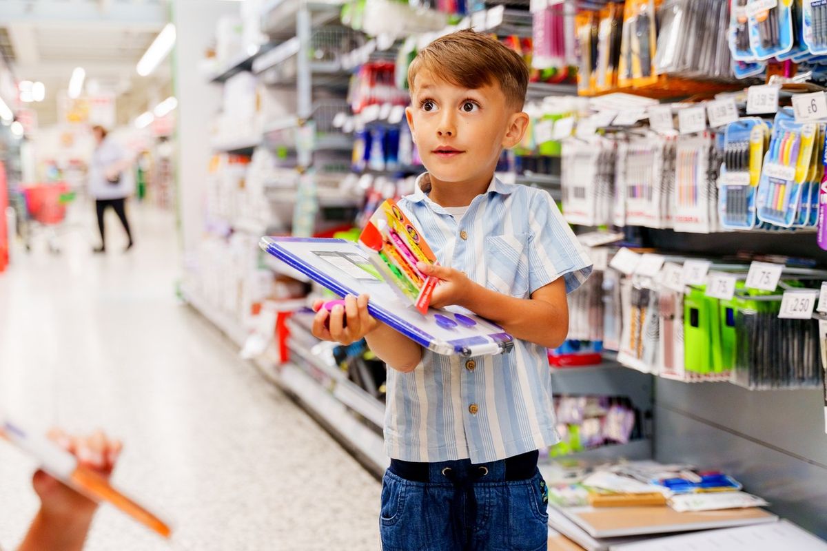 UK children shopping with parents for back-to-school supplies in 2025, choosing stationery items