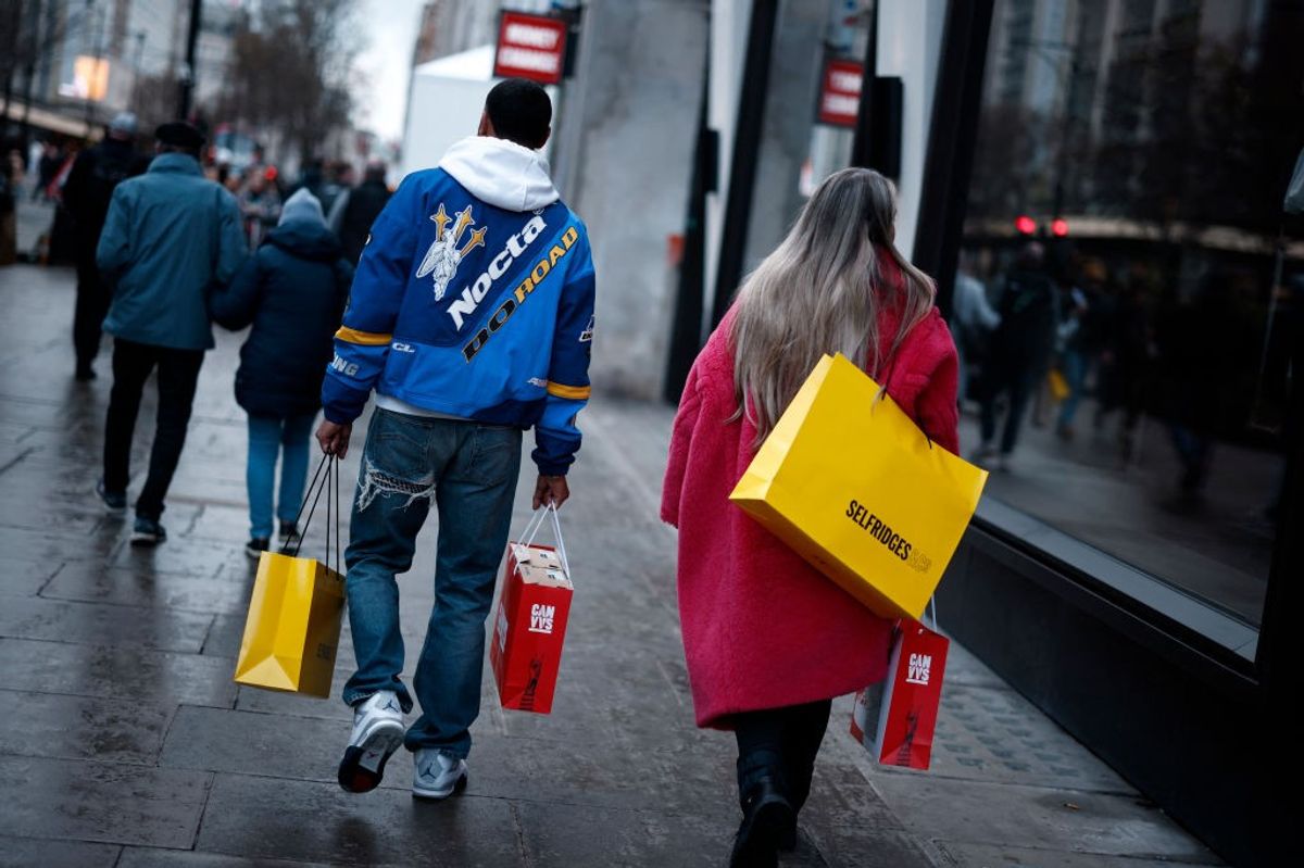 UK retail sales shoppers with bags on street in February 2025