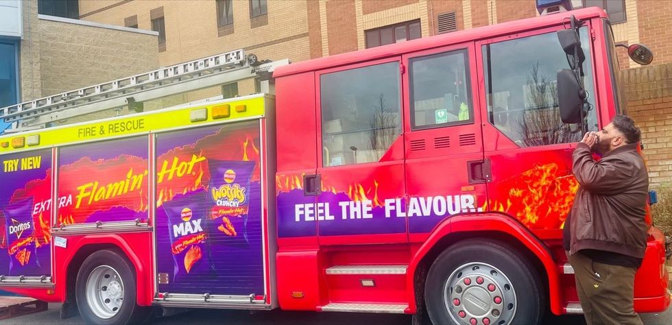 Walkers Extra Flamin\u2019 Hot activation with fire truck and branded POS outside a convenience store