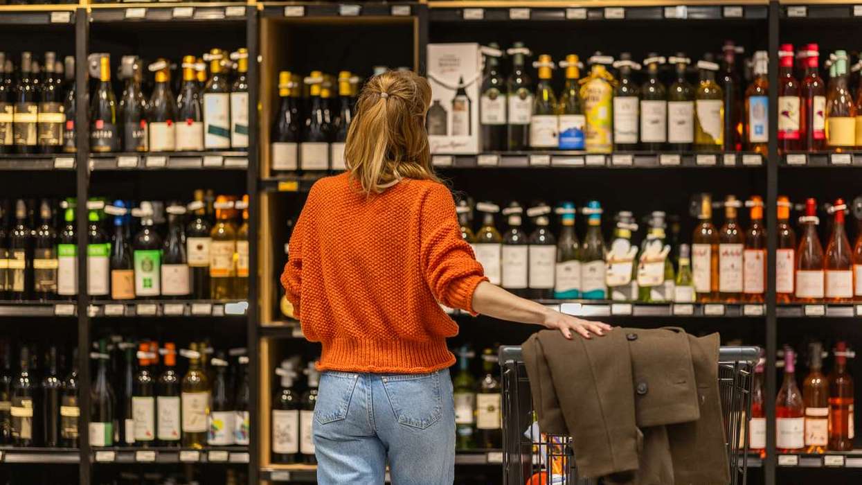 Woman shopping in a liquor store aisle