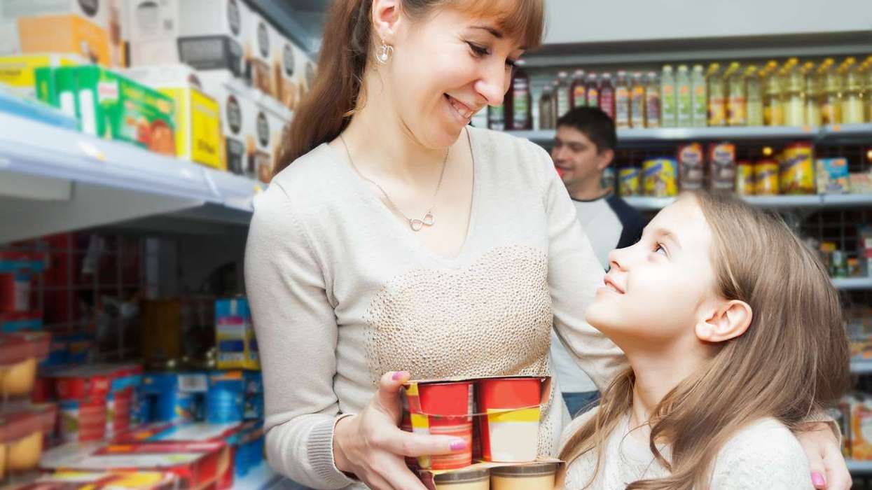 Woman with daughter buying sweet yoghurts