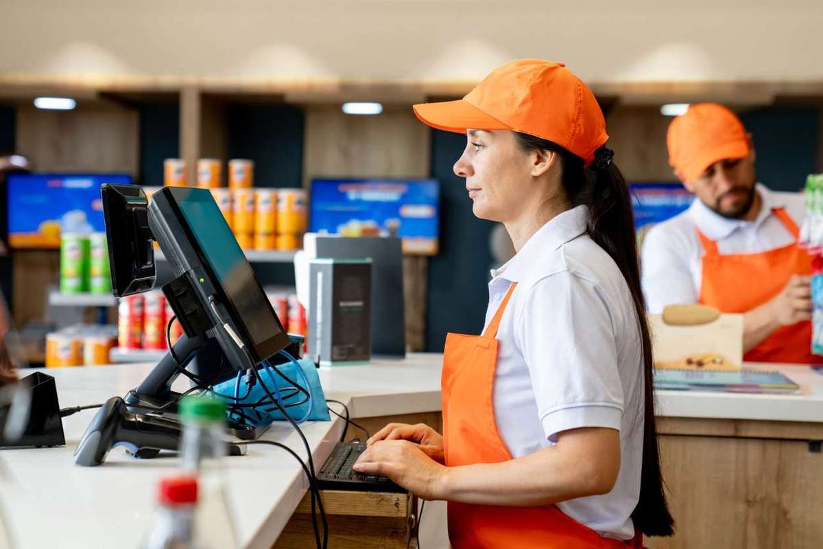 Woman working at the cashier in a convenience store