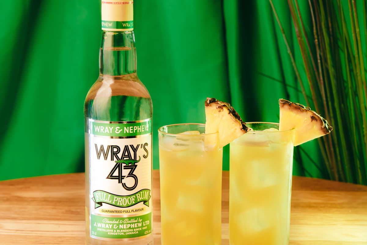 Wray’s 43 limited-edition Jamaican white rum bottle with tropical background