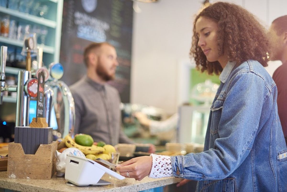 Young UK consumers using digital wallets like Apple Pay over traditional cash payments