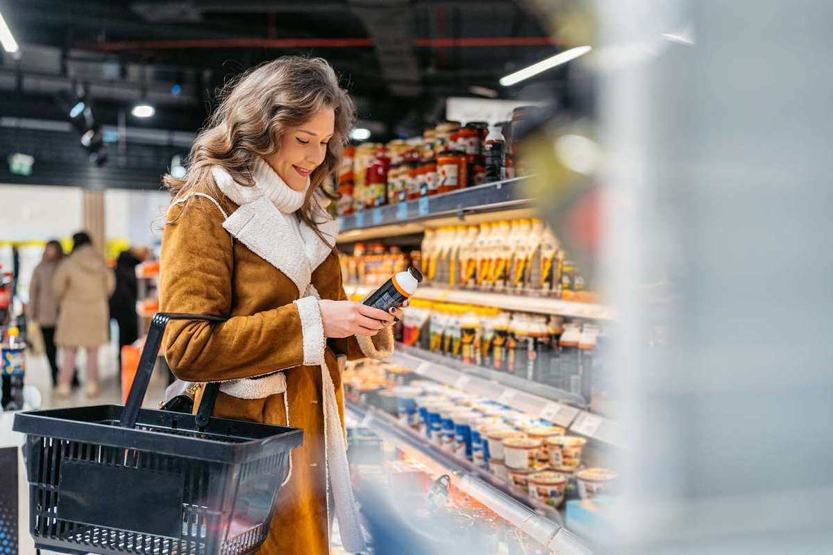 Young Woman Buying A Protein Drink In A Supermarket