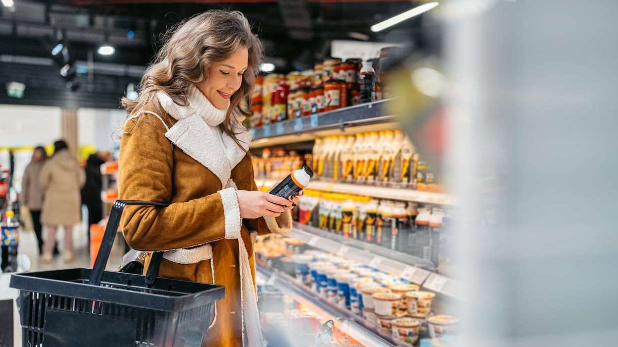 Young Woman Buying A Protein Drink In A Supermarket